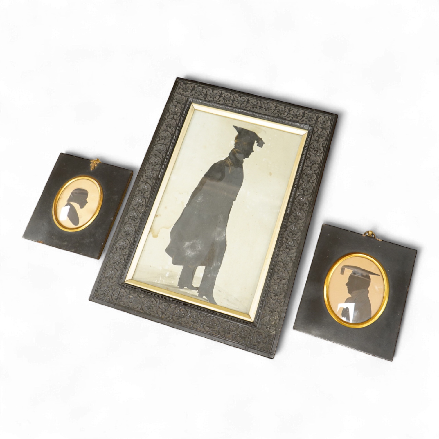 Early 19th century, English School, Cut paper silhouette portrait of a young man in academic robes and mortar board, together with two other silhouette portraits, with inscriptions verso, to include Reverend Lowry Guthri